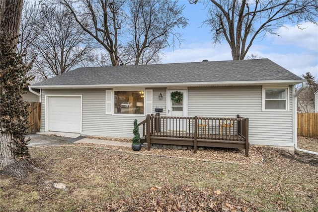 ranch-style home with a garage and a deck