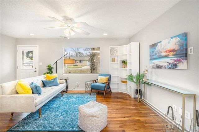 sitting room featuring hardwood / wood-style floors, a textured ceiling, and ceiling fan