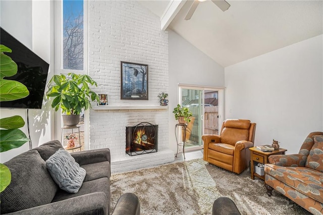 carpeted living room with beam ceiling, a fireplace, high vaulted ceiling, and ceiling fan