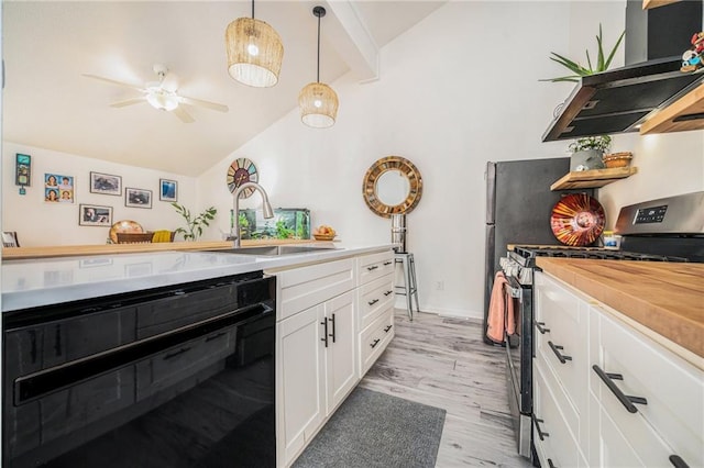 kitchen featuring decorative light fixtures, stainless steel gas stove, black dishwasher, sink, and white cabinets