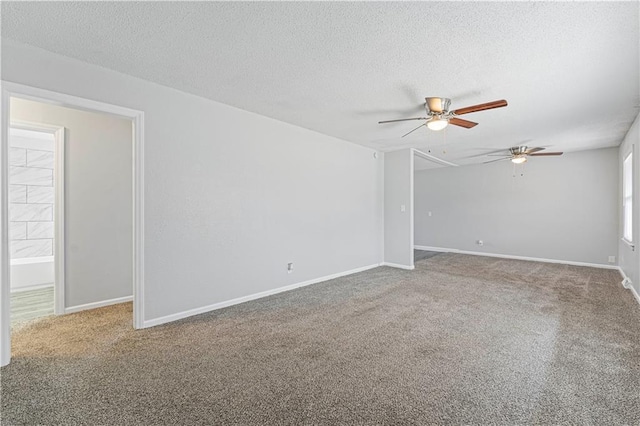 spare room featuring ceiling fan, a textured ceiling, and carpet