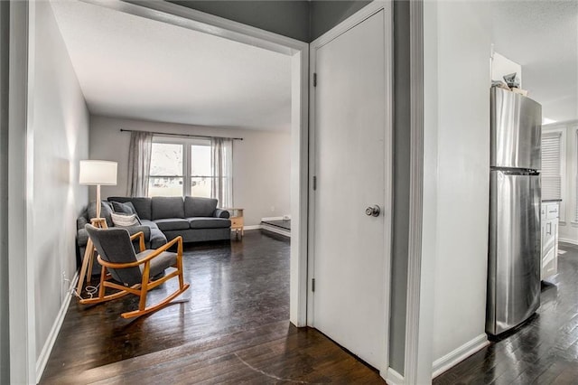 corridor with baseboards and dark wood-style floors