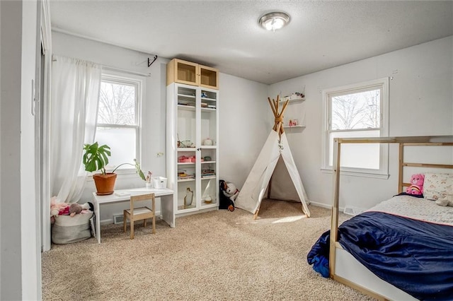 carpeted bedroom with a textured ceiling