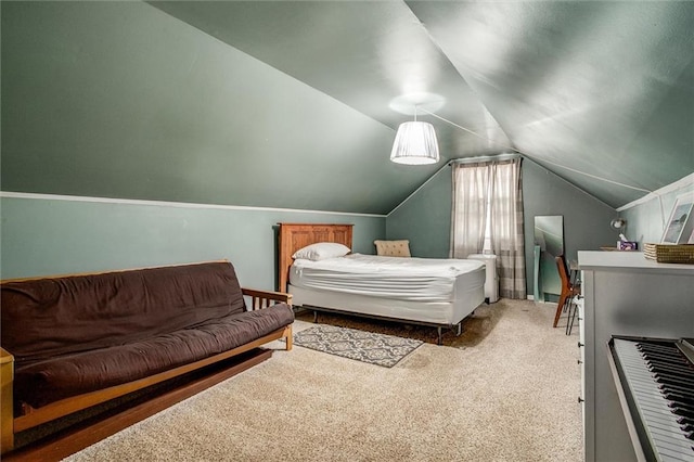 carpeted bedroom with lofted ceiling