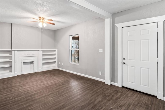 unfurnished living room featuring ceiling fan, dark hardwood / wood-style flooring, and a textured ceiling