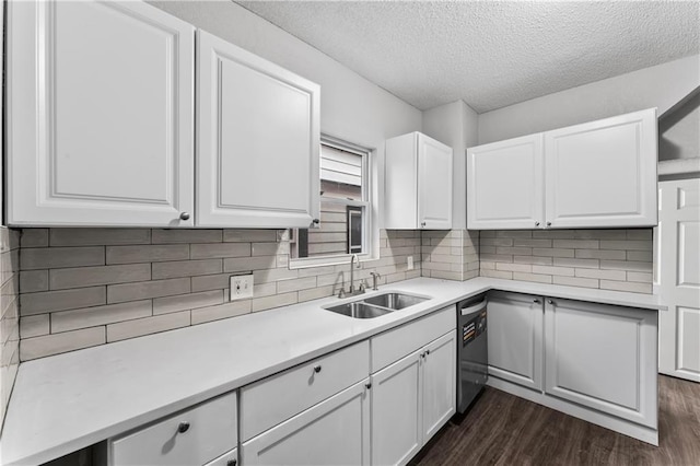 kitchen with dark hardwood / wood-style floors, black dishwasher, sink, and white cabinets