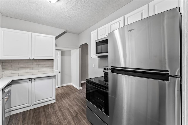 kitchen with white cabinetry, appliances with stainless steel finishes, dark wood-type flooring, and tasteful backsplash