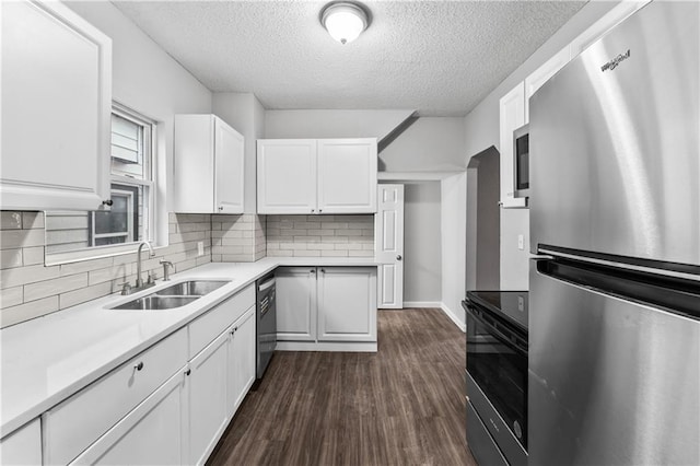 kitchen featuring dark wood-type flooring, stainless steel appliances, sink, and white cabinets