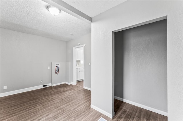 unfurnished bedroom with wood-type flooring and a textured ceiling