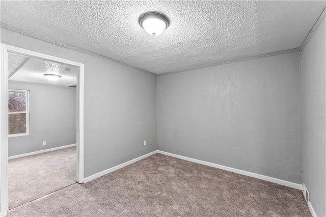 carpeted spare room featuring a textured ceiling