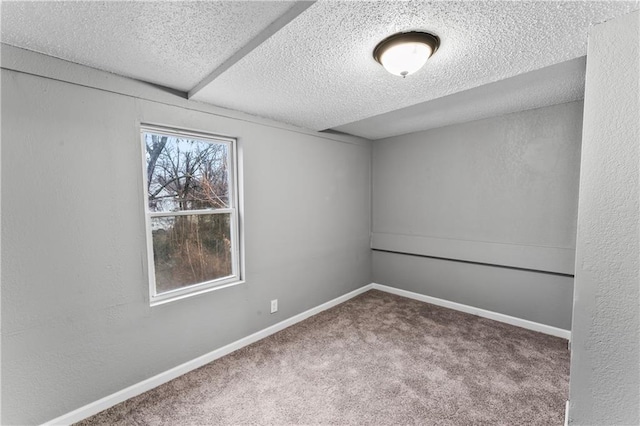 carpeted empty room with a textured ceiling