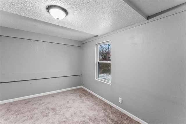 empty room with a textured ceiling and carpet