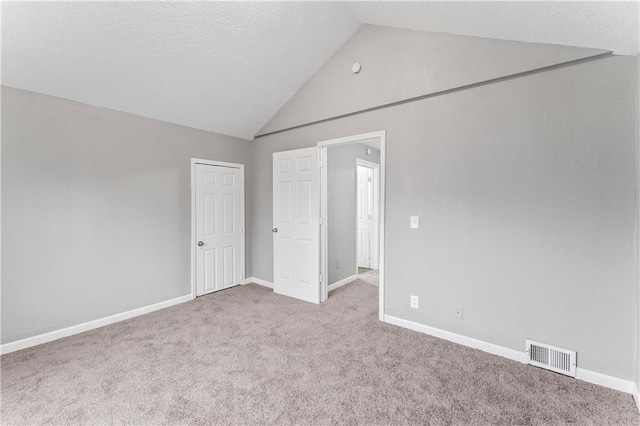 interior space with lofted ceiling and light colored carpet