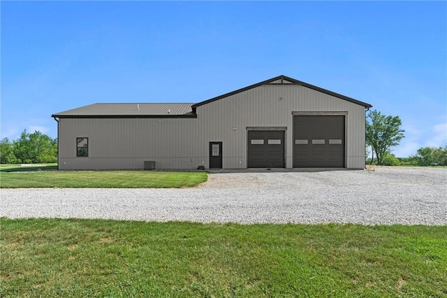 16140 214th St, Tonganoxie, KS 66086 - view of home's exterior featuring a lawn, an outbuilding, and a garage