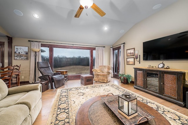 living room featuring lofted ceiling, light wood-style flooring, a ceiling fan, recessed lighting, and baseboards