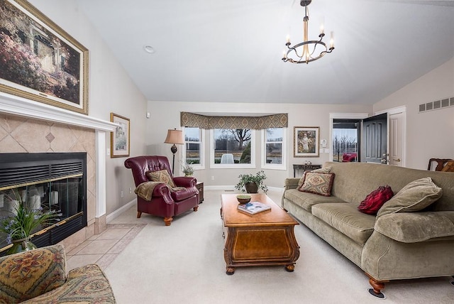 carpeted living area featuring visible vents, a fireplace, baseboards, a chandelier, and vaulted ceiling