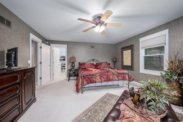 bedroom featuring visible vents, carpet flooring, and ceiling fan