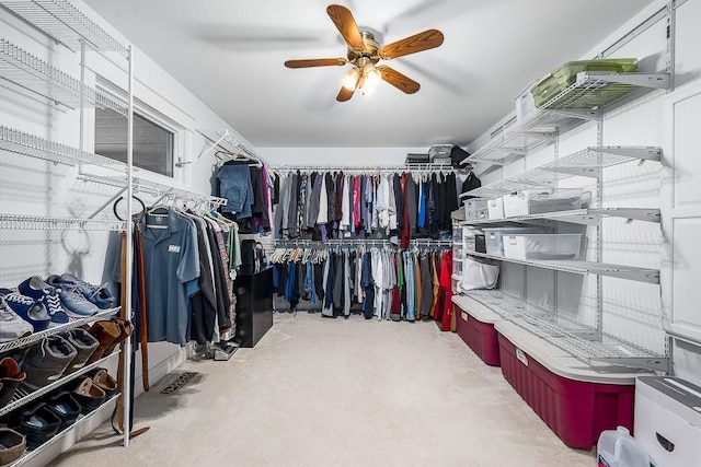 walk in closet with a ceiling fan