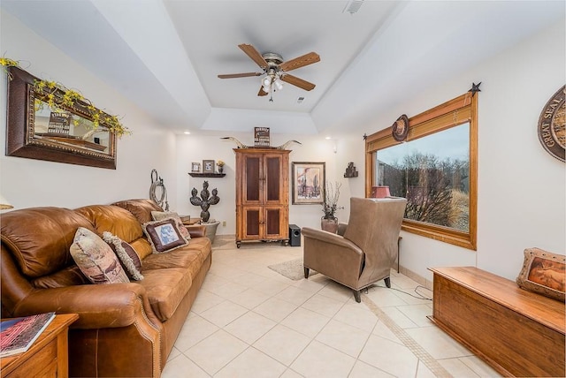 living room with a raised ceiling, light tile patterned floors, recessed lighting, and ceiling fan