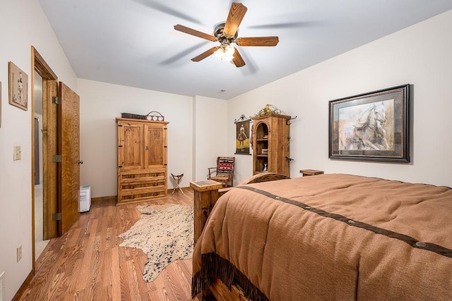 bedroom featuring wood finished floors and ceiling fan