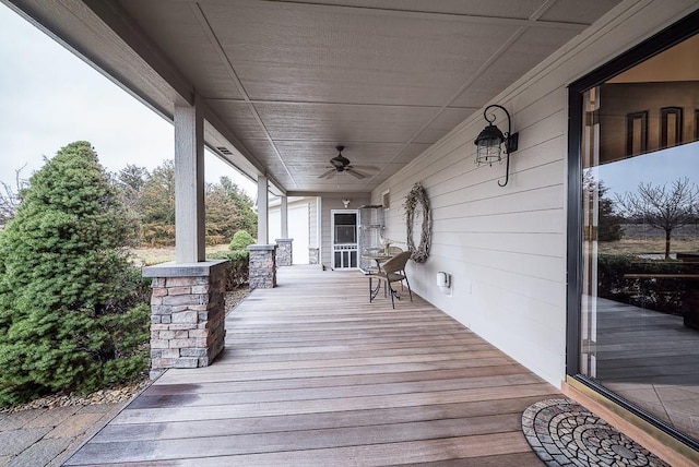 wooden terrace with covered porch and ceiling fan