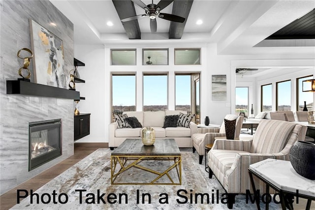 living area with a fireplace, recessed lighting, a ceiling fan, wood finished floors, and beamed ceiling