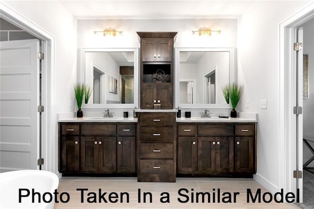 full bathroom featuring tile patterned floors, a sink, and double vanity