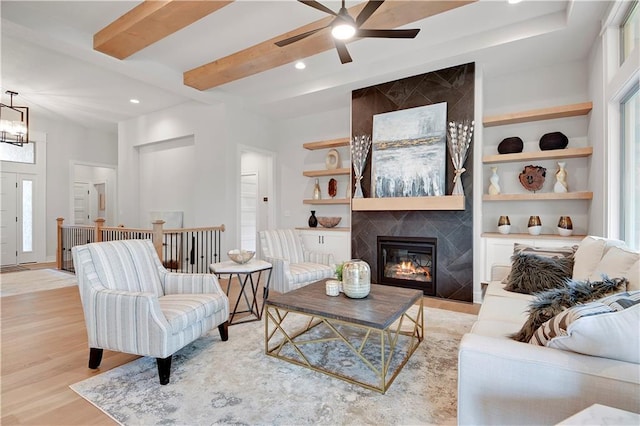 22109 W 93rd Ter, Lenexa, KS 66220 - living area with light wood-style floors, ceiling fan, recessed lighting, a tile fireplace, and beam ceiling