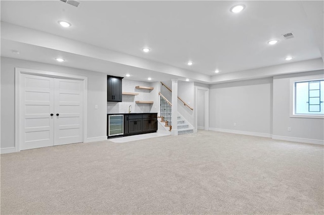 22109 W 93rd Ter, Lenexa, KS 66220 - basement with wine cooler, light carpet, bar with sink, stairway, and recessed lighting