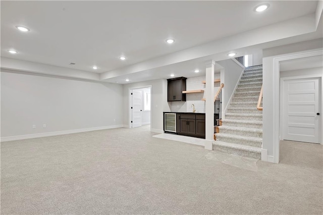 22109 W 93rd Ter, Lenexa, KS 66220 - unfurnished living room with light carpet, recessed lighting, beverage cooler, and stairs