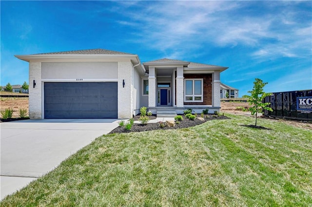 22109 W 93rd Ter, Lenexa, KS 66220 - prairie-style home with a garage, brick siding, a front yard, and driveway