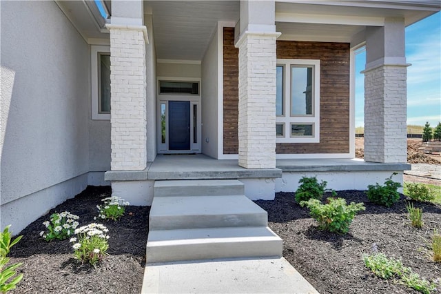 22109 W 93rd Ter, Lenexa, KS 66220 - doorway to property featuring covered porch and stucco siding