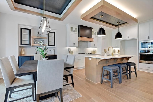 22109 W 93rd Ter, Lenexa, KS 66220 - dining area with a raised ceiling and light wood finished floors