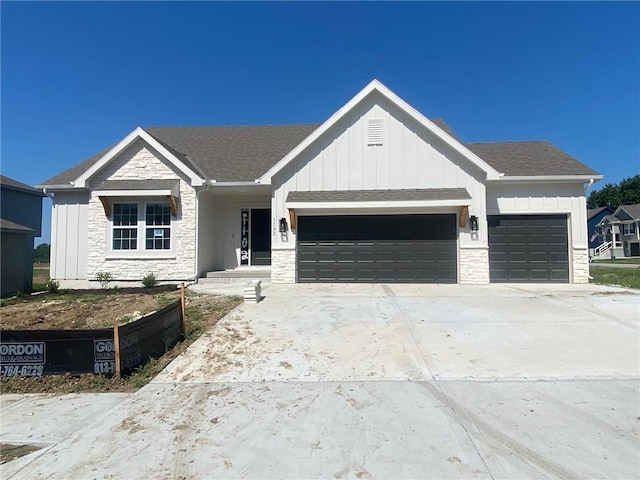 1102 Noah Ln, Kearney, MO 64060 - view of front of house featuring stone siding, an attached garage, board and batten siding, driveway, and roof with shingles