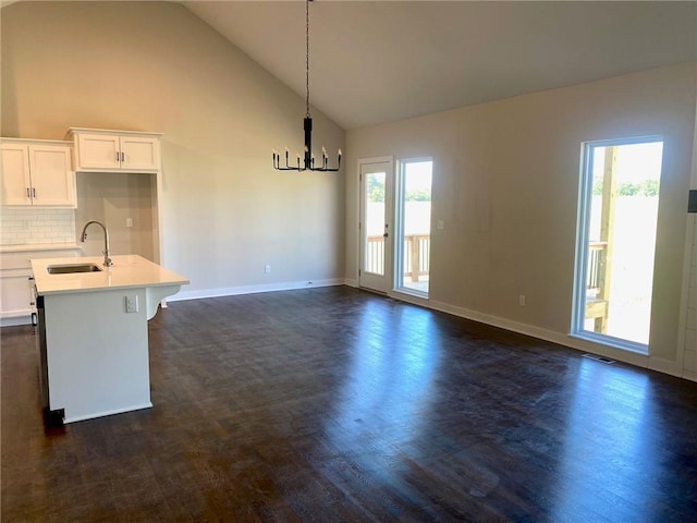 1102 Noah Ln, Kearney, MO 64060 - kitchen with dark wood-style floors, light countertops, plenty of natural light, and high vaulted ceiling