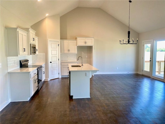 1102 Noah Ln, Kearney, MO 64060 - kitchen with appliances with stainless steel finishes, dark wood-style flooring, light countertops, an island with sink, and white cabinets