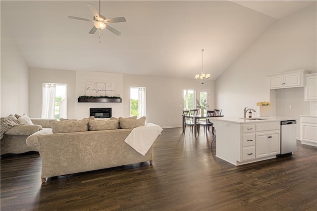 1102 Noah Ln, Kearney, MO 64060 - living area featuring a glass covered fireplace, dark wood finished floors, a ceiling fan, high vaulted ceiling, and a chandelier