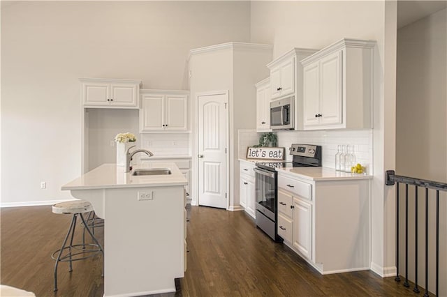 1102 Noah Ln, Kearney, MO 64060 - kitchen featuring appliances with stainless steel finishes, white cabinetry, and decorative backsplash