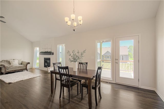 1102 Noah Ln, Kearney, MO 64060 - dining room with dark wood-style floors, healthy amount of natural light, a chandelier, and vaulted ceiling