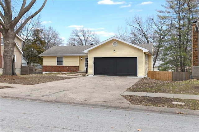 single story home featuring brick siding, an attached garage, concrete driveway, and fence