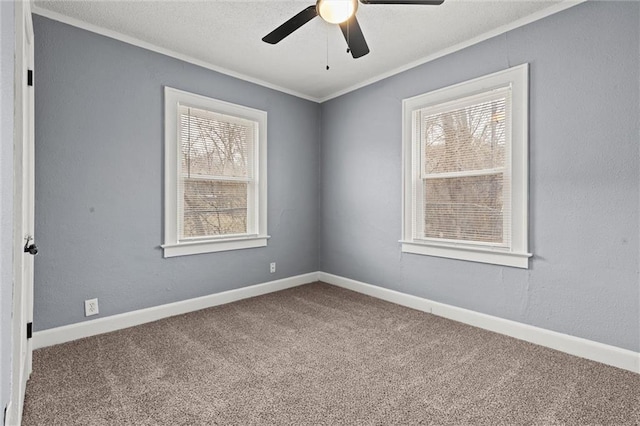 carpeted spare room with crown molding and ceiling fan