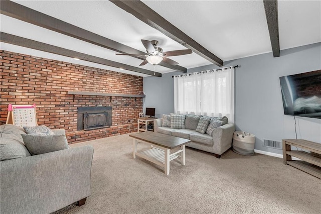 carpeted living room with ceiling fan, brick wall, a fireplace, and beam ceiling