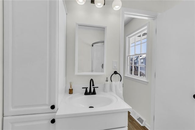 bathroom with vanity and hardwood / wood-style floors