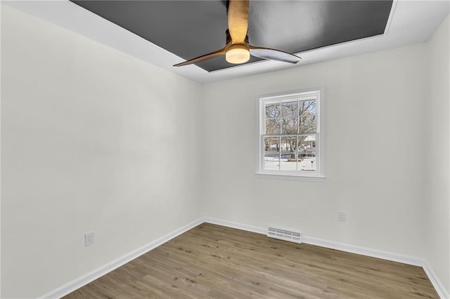 empty room featuring hardwood / wood-style floors and ceiling fan