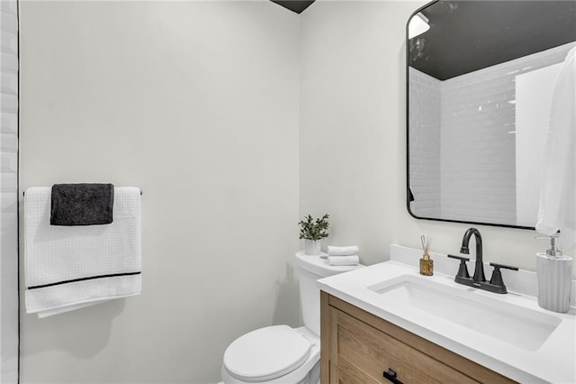 bathroom featuring vanity and toilet