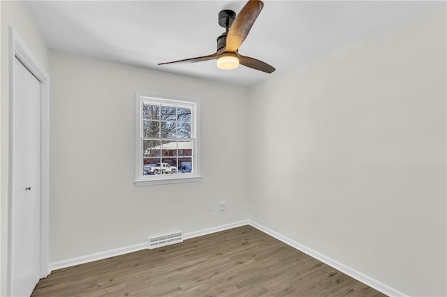 unfurnished bedroom featuring hardwood / wood-style floors, ceiling fan, and a closet