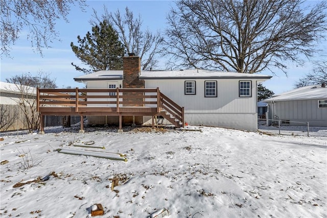 snow covered property featuring a deck