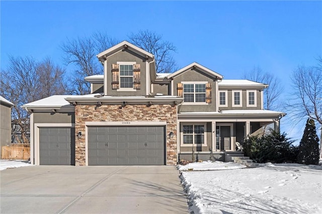 view of front of house with driveway, stone siding, a porch, and stucco siding