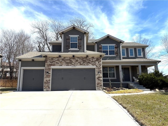 view of front facade with driveway, stone siding, and stucco siding