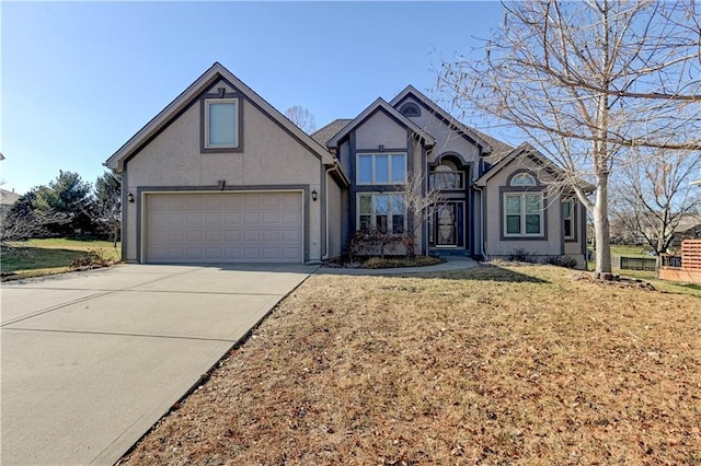 view of front of home with a garage and a front lawn